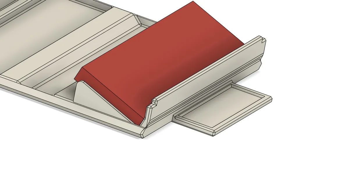 CAD detail of the piece holder showing a red road piece seated in its channel.