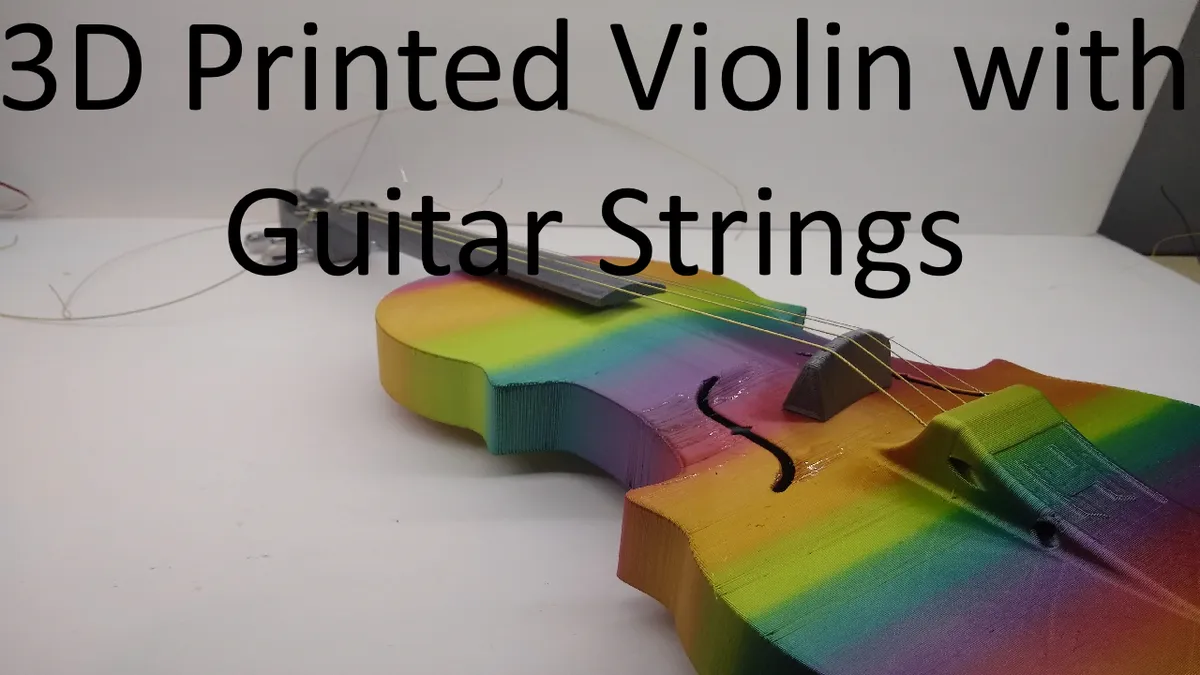 A rainbow-colored printed violin in an original video thumbnail labeled 3D Printed Violin with Guitar Strings.