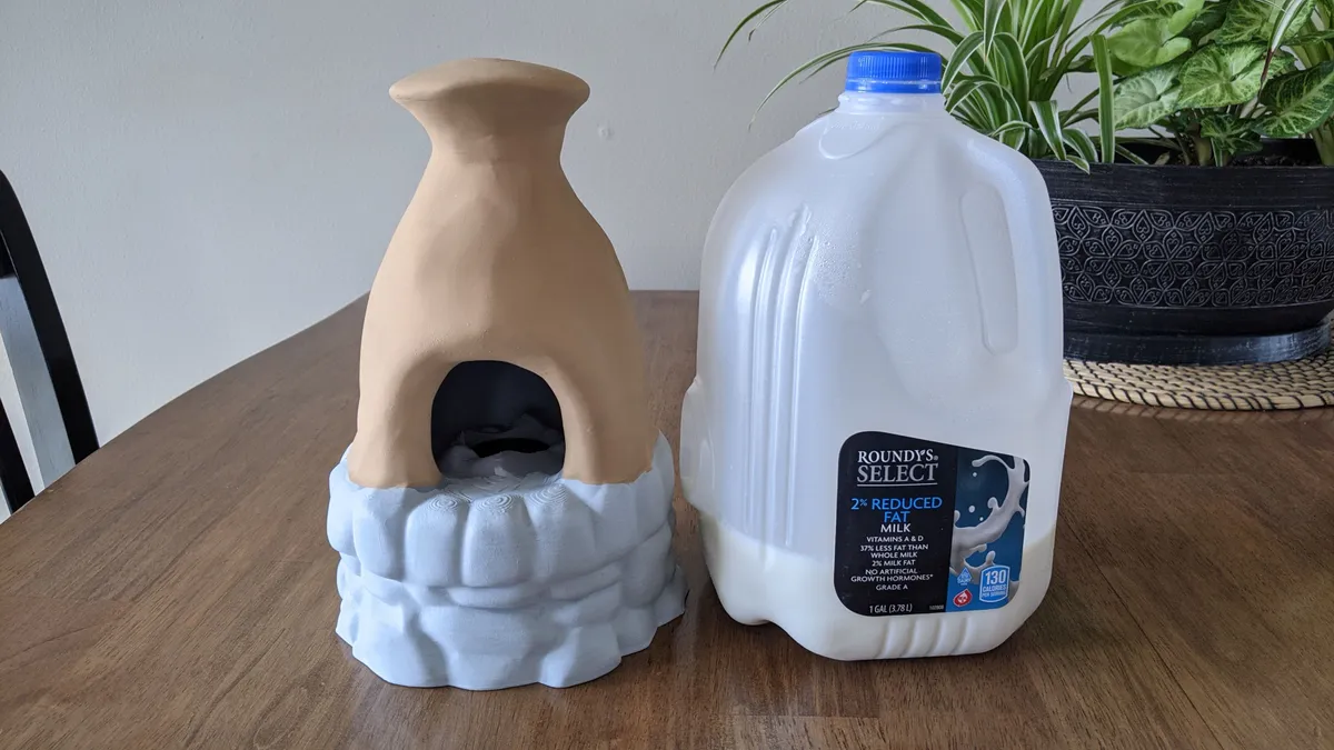 A larger printed furnace beside a gallon jug for scale.