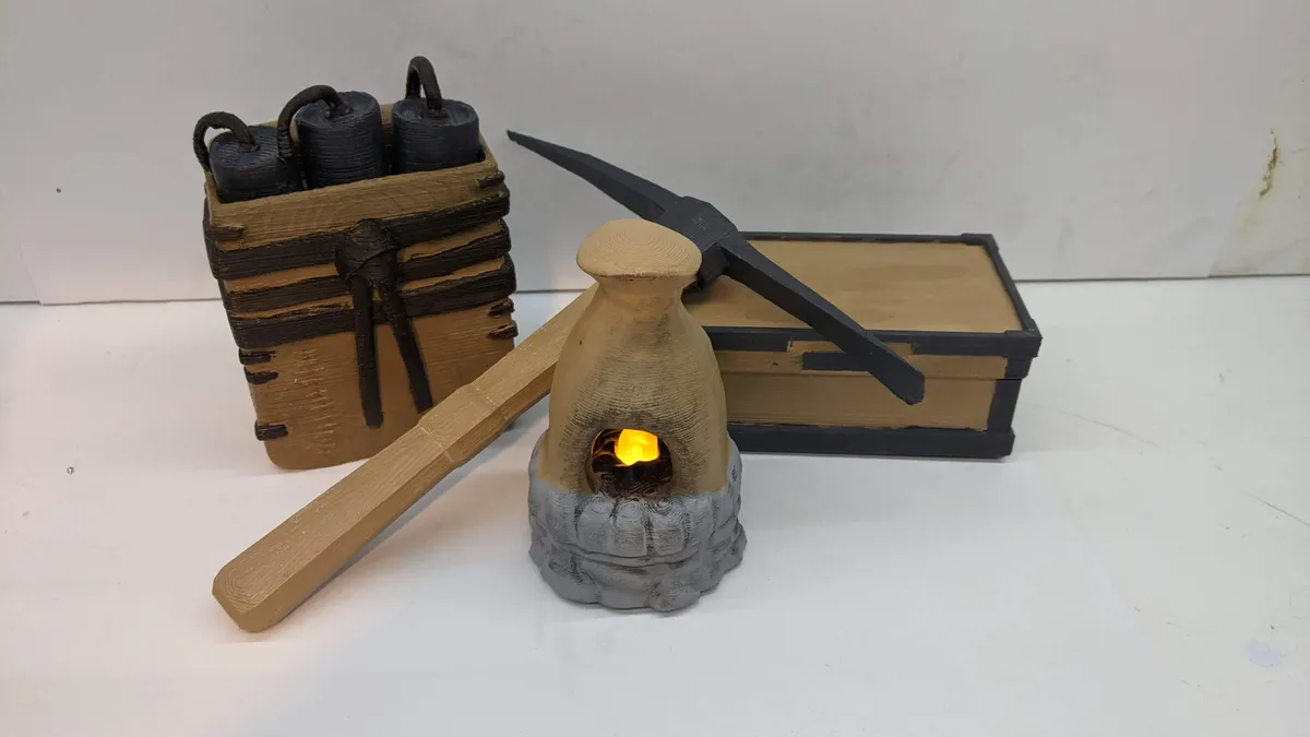 Hand-painted Rust-inspired satchel, pickaxe, storage chest, and glowing miniature furnace arranged together.