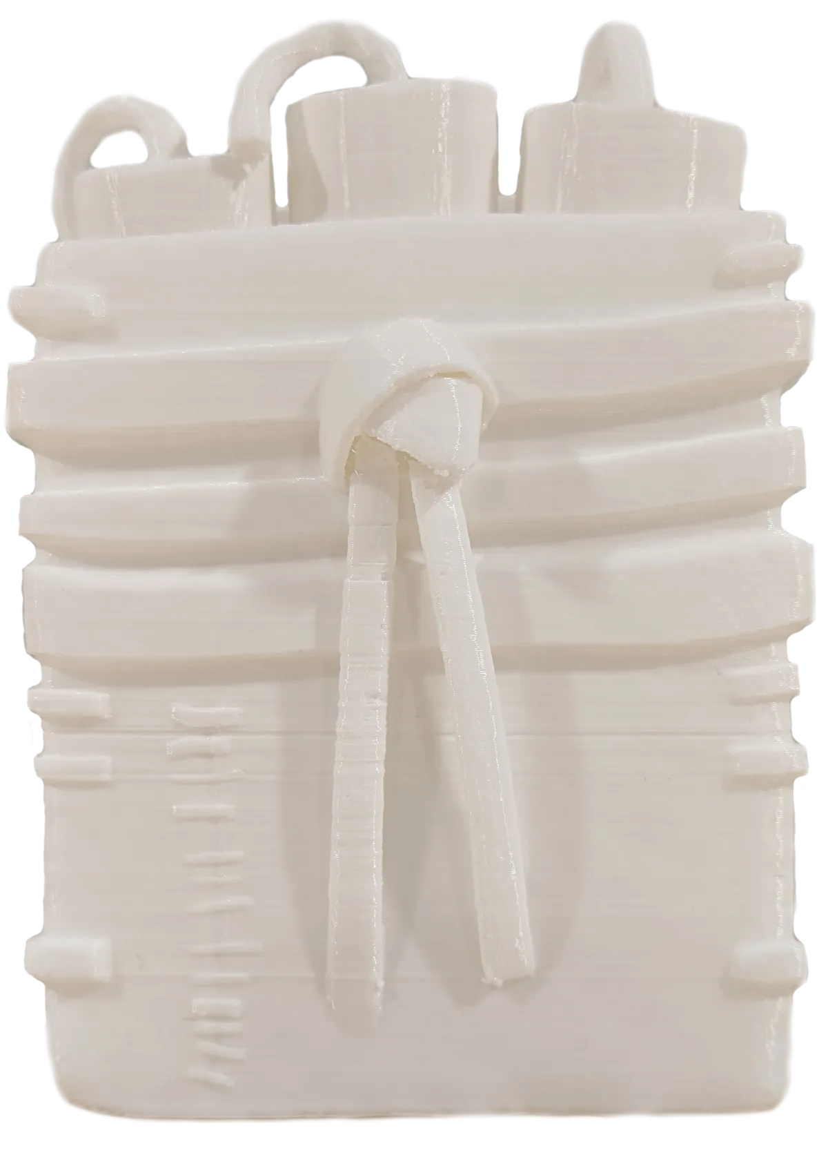 An unpainted white satchel display prop with raised straps, loops, and cylindrical details.