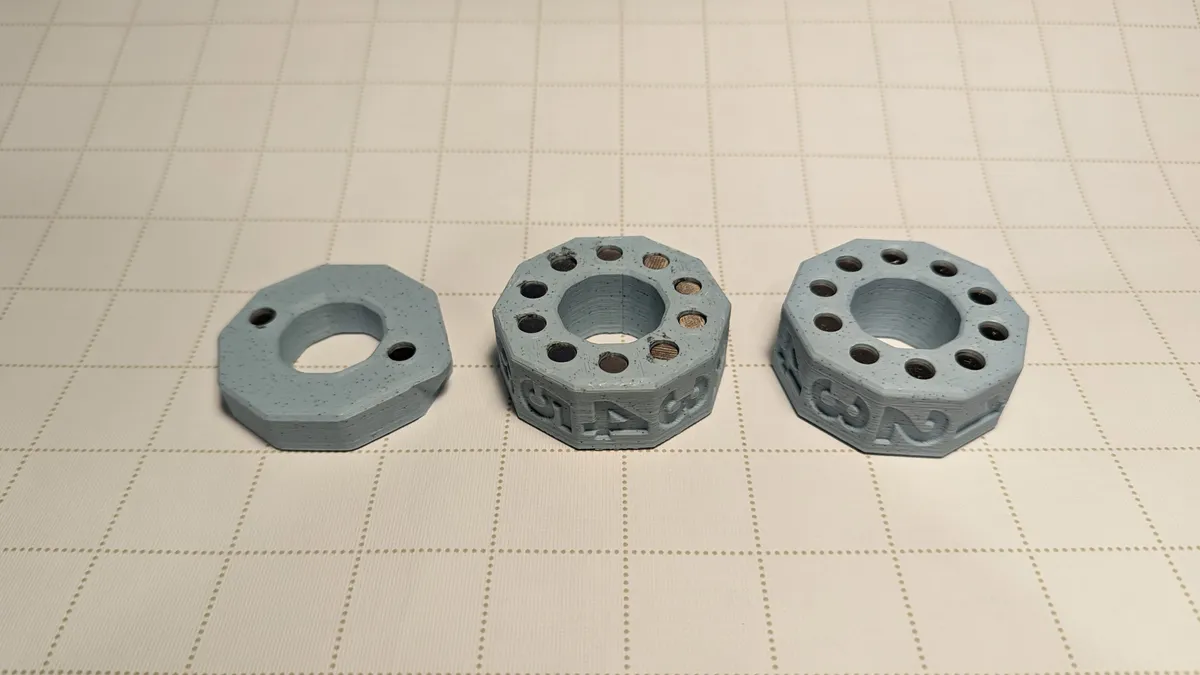 Separate gray printed numbered rings and end pieces for a tabletop counter.