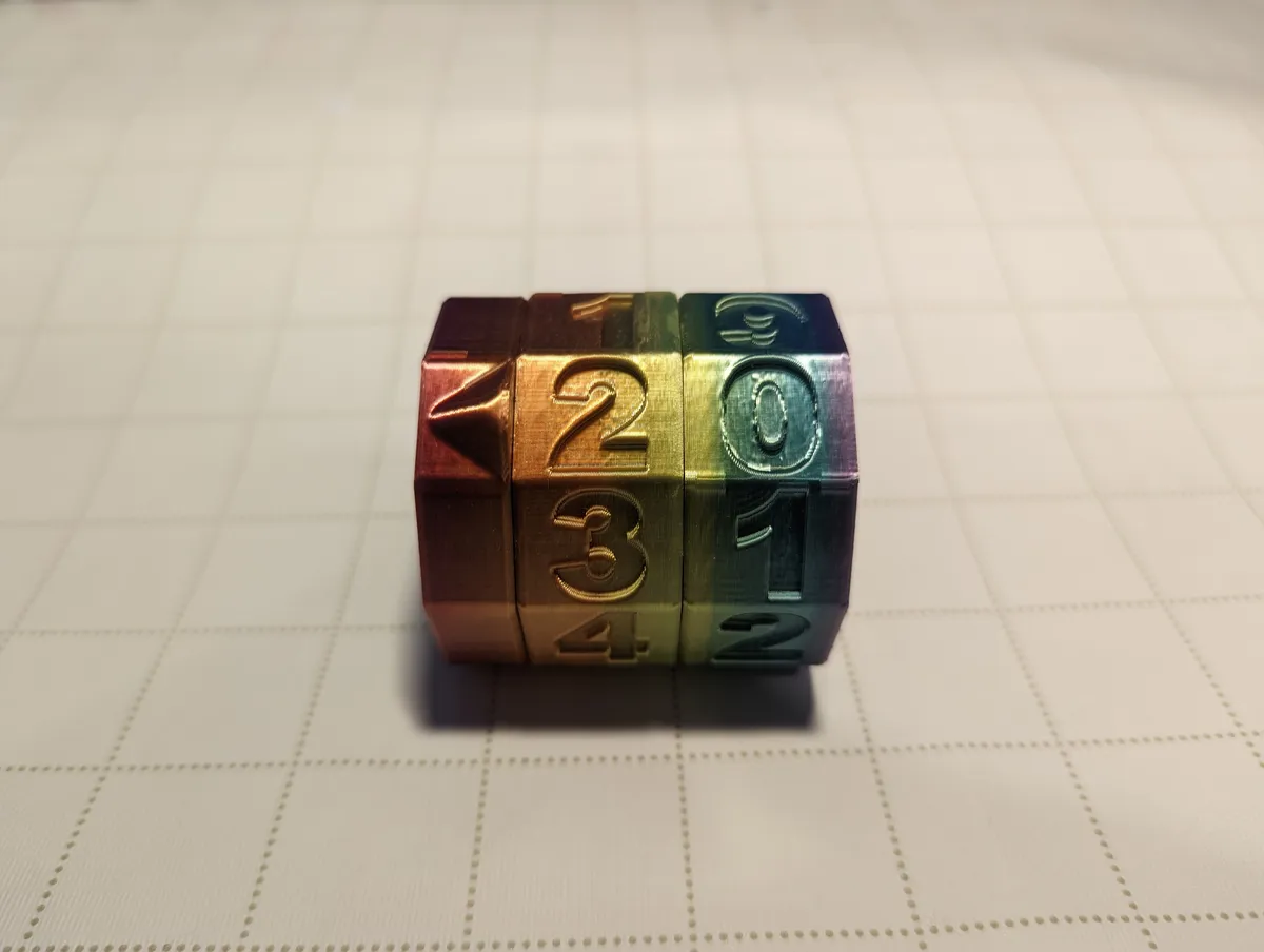 An assembled multicolored tabletop life counter with raised numbers on its rotating rings.
